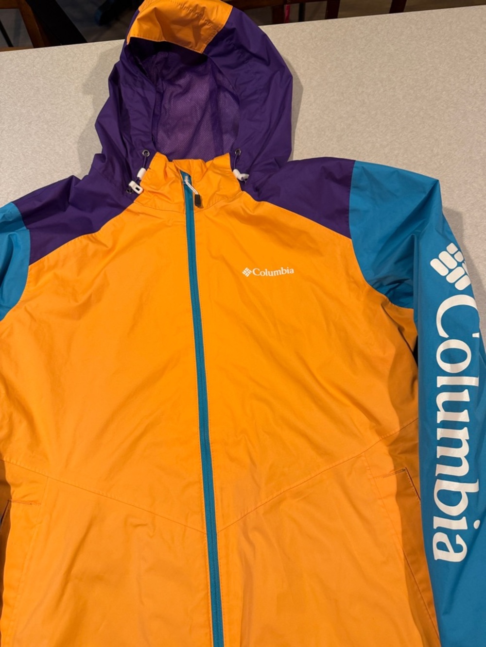 Columbia Womens Orange Raincoat with Teal and Purple Accents